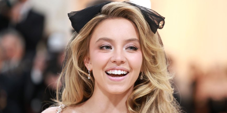 Sydney Sweeney Stuns in Daring Black Lace Bodysuit and Feather Boots