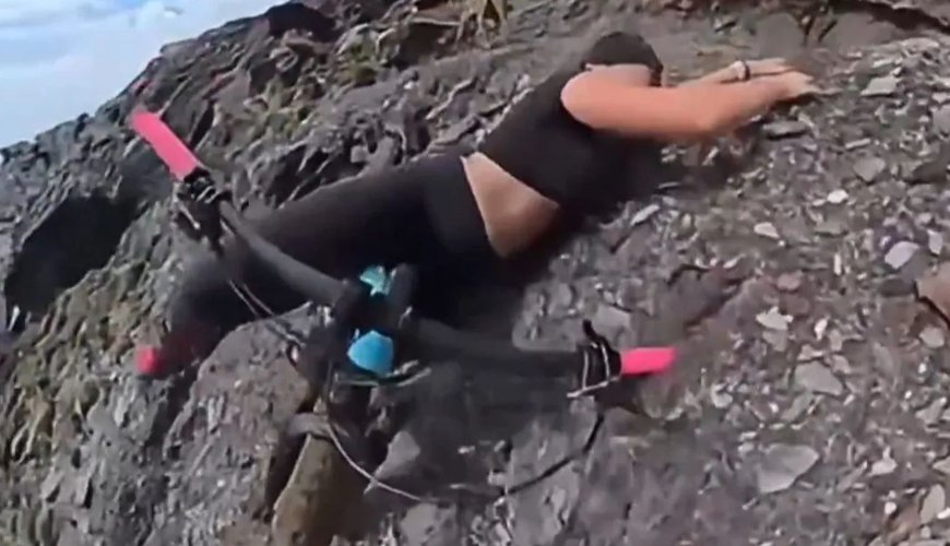 Daredevil Cycling Beauty's Cliffhanger Adventure with Her Loyal Pup